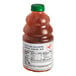 A bottle of Dr. Smoothie Red Apple fruit smoothie mix with a green cap.