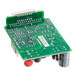 A close-up of a green Seko circuit board with many small round objects.