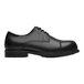 A black Shoes For Crews Senator dress shoe with a rubber sole.