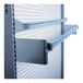 A Retail Space Solutions Magna-Bar metal shelf with a horizontal extension attached to a metal beam.