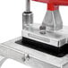 A metal device with a red handle on top for Vollrath Redco InstaCut 3.5.