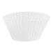 A close up of a white paper cupcake liner with fluted edges.