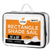 A white rectangular Xpose Safety shade sail in a white bag with an orange label.