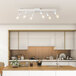 A Globe matte white track light fixture in a modern white kitchen.