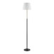 A tall black floor lamp with a white lamp shade.