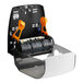 A black and orange Scott Slimroll wall mount paper towel dispenser.