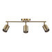 A Globe matte brass track light fixture with three pivoting cylindrical spotlights.