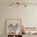 A Globe matte brass track light in a white room.