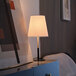 A Globe 17" Minimalist Matte Black / Matte Brass table lamp on a white table.