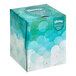 A Kleenex tissue box with blue and white clouds.