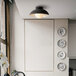 A Globe Lofty matte black flush mount light fixture above a kitchen sink.