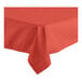 A red Oxford square tablecloth with a folded edge on a table.