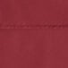 A close up of a burgundy Oxford table cover with a hemmed edge.