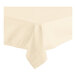 A close-up of the corner of an ivory Oxford square tablecloth with a folded edge.
