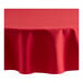 A red Oxford round tablecloth on a table.