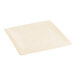 An ivory hemmed edge cloth table cover folded on a table.