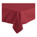 A burgundy square table cover with a folded edge on a table.