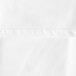 A close up of an Oxford white round tablecloth with a hemmed edge.