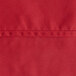 A close up of a red hemmed Oxford cloth table cover.