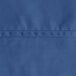 A close-up of a royal blue fabric with a white hem.