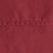 A close-up of burgundy hemmed fabric.