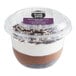 A plastic container with white and brown chocolate mousse.