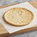 A Rich's Gluten-Free cauliflower pizza crust on a wooden board.