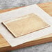 A rectangular piece of Rich's cobbler crust dough on a wooden surface.