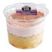 A plastic container of Our Specialty Treat Shop Strawberry Tres Leches Cake with a label and a strawberry on top.