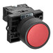 A black plastic switch with a red push button.