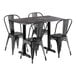 A Lancaster Table & Seating black metal table with metal chairs on a white background.