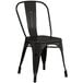 A black metal chair with a seat and back.