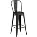 A Lancaster Table & Seating black metal bar stool with a backrest.