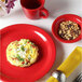 A Tuxton Cayenne Colorado tall cup with a plate of food and a mug of coffee.