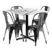 A Lancaster Table & Seating black metal table with a white surface and four black chairs.