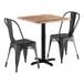 A Lancaster Table & Seating square textured Yukon oak table with two black metal chairs.