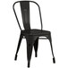 A black metal chair with a seat and back.