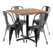 A Lancaster Table & Seating Yukon Oak table with black metal chairs.