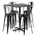 A Lancaster Table & Seating black metal bar table with four black barstools.