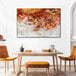 A 36" x 24" Elephant Stock canvas wall art painting with red and gold details hanging on a wall.