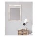 A BrandtWorks cream farmhouse grain finish mirror with a wooden frame on a wall.