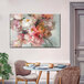 A 39" x 26" canvas wall art of a blush bouquet of flowers on a wall.