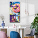 A 30" x 60" canvas wall art of flowers in a blue vase on a white table.