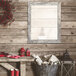 A rustic wooden wall mirror with a distressed white finish.