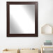 A BrandtWorks modern espresso finish mirror with a brown frame on a shelf.