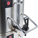 A Grindmaster stainless steel coffee shuttle and warmer on a counter.