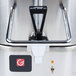 A Grindmaster stainless steel coffee shuttle on a warmer.