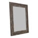 A BrandtWorks wooden mirror with a distressed dark brown frame.