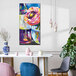 A canvas wall art painting of flowers in a blue and white vase.
