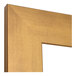 A close up of the gold frame on a BrandtWorks Brushed Gold Finish Mirror.
